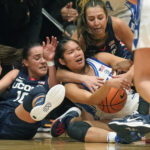 
              Duke guard Vanessa de Jesus, center, battles for the ball against Connecticut's Nika Muhl (10) and Caroline Ducharme, right rear, during the first half of an NCAA college basketball game in the Phil Knight Legacy tournament Friday, Nov. 25, 2022, in Portland, Ore. (AP Photo/Rick Bowmer)
            