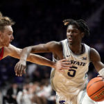
              Kansas State guard Cam Carter (5) drives under pressure from Texas-Rio Grande Valley guard Will Johnston (4) during the second half of an NCAA college basketball game Monday, Nov. 7, 2022, in Manhattan, Kan. (AP Photo/Charlie Riedel)
            