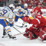 
              Detroit Red Wings goaltender Alex Nedeljkovic (39) stops a Buffalo Sabres center Vinnie Hinostroza (29) shot in the second period of an NHL hockey game Wednesday, Nov. 30, 2022, in Detroit. (AP Photo/Paul Sancya)
            