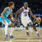 Philadelphia 76ers guard Shake Milton (18) drives around Charlotte Hornets guard Kelly Oubre Jr. (12) during the second half of an NBA basketball game Wednesday, Nov. 23, 2022, in Charlotte, N.C. (AP Photo/Rusty Jones)