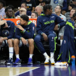 The Minnesota Timberwolves bench watches during the second half of an NBA basketball game against the Phoenix Suns, Tuesday, Nov. 1, 2022, in Phoenix. (AP Photo/Matt York)