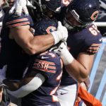 
              Chicago Bears tight end Cole Kmet, left, is congratulated by running back Khalil Herbert (24) and outside linebacker Cody Whitehair (65) after Kmet scored during the first half of an NFL football game against the Miami Dolphins, Sunday, Nov. 6, 2022 in Chicago. (AP Photo/Nam Y. Huh)
            