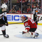 Arizona Coyotes right wing Clayton Keller (9) scores a goal against New Jersey Devils goaltender Akira Schmid (40) during the second period of an NHL hockey game, Saturday, Nov. 12, 2022, in Newark, N.J. (AP Photo/Noah K. Murray)