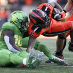 
              Oregon State running back Damien Martinez (6) is brought down by Oregon defensive back Jamal Hill (19) during the first half of an NCAA college football game on Saturday, Nov 26, 2022, in Corvallis, Ore. (AP Photo/Amanda Loman)
            