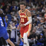 Atlanta Hawks guard Trae Young (11) reacts after a score during the second half of the team's NBA basketball game against the Orlando Magic, Wednesday, Nov. 30, 2022, in Orlando, Fla. (AP Photo/Phelan M. Ebenhack)