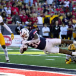 Arizona running back DJ Williams (32) scores a touchdown against Arizona State in the second half during an NCAA college football game, Friday, Nov. 25, 2022, in Tucson, Ariz. (AP Photo/Rick Scuteri)