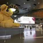FILE - A giant teddy bear adorns the Hamad International Airport in Doha, Qatar, May 6, 2018. Just as soccer fans going to a game in a European city might take a metro, tens of thousands of foreigners attending the World Cup in Qatar this month are commuting to matches by air. (AP Photo/Kamran Jebreili, File)