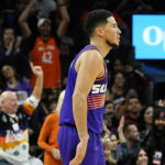 Phoenix Suns fans cheer on Suns guard Devin Booker after he scored against the Chicago Bulls during the second half of an NBA basketball game in Phoenix, Wednesday, Nov. 30, 2022. The Suns won 132-113. (AP Photo/Ross D. Franklin)