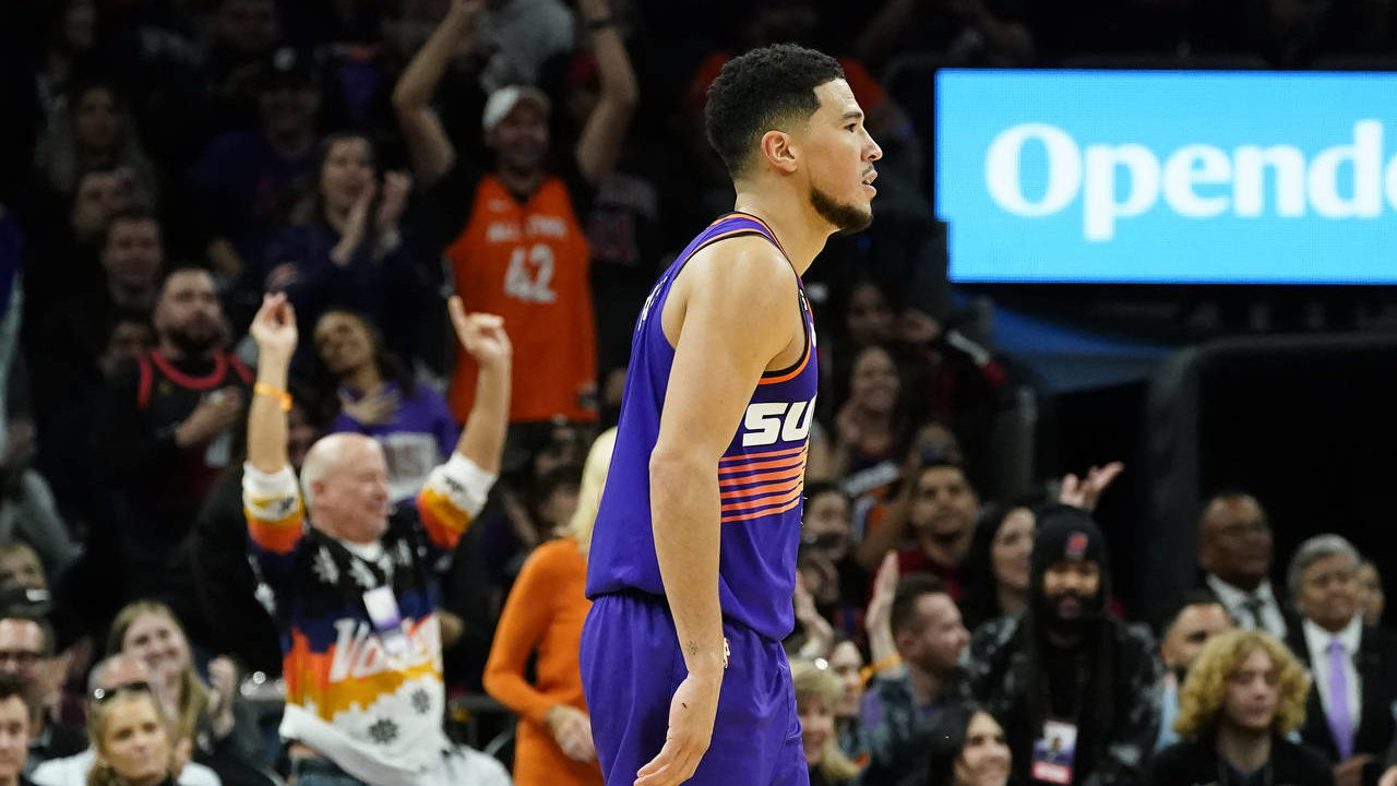Phoenix Suns fans cheer on Suns guard Devin Booker after he scored against the Chicago Bulls during...