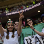 Soccer fans from Iran poses for a picture prior to the World Cup group B soccer match between Wales and Iran, at the Ahmad Bin Ali Stadium in Al Rayyan , Qatar, Friday, Nov. 25, 2022. (AP Photo/Francisco Seco)