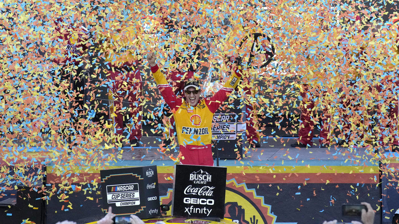 Joey Logano celebrates after winning a NASCAR Cup Series auto race and championship Sunday, Nov. 6,...