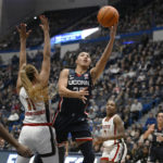 
              Connecticut's Azzi Fudd (35) goes up for a basket against NC State's Jakia Brown-Turner (11) during the first half of an NCAA basketball game, Sunday, Nov. 20, 2022, in Hartford, Conn. (AP Photo/Jessica Hill)
            