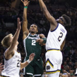 
              Michigan State's Tyson Walker, middle, is fouled by Notre Dame's Ven-Allen Lubin, right, during the first half of an NCAA college basketball game Wednesday, Nov. 30, 2022, in South Bend, Ind. (AP Photo/Michael Caterina)
            