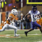 
              Texas defensive back Jahdae Barron (23) tracks TCU wide receiver Derius Davis (11) during the first half of an NCAA college football game Saturday, Nov. 12, 2022, in Austin, Texas. (AP Photo/Stephen Spillman)
            