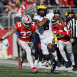
              Michigan receiver Cornelius Johnson, front, outruns Ohio State defenders Cameron Brown, right, and Brenten Jones to score a touchdown during the first half of an NCAA college football game on Saturday, Nov. 26, 2022, in Columbus, Ohio. (AP Photo/Jay LaPrete)
            