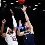 Michigan's Hunter Dickinson (1) shoots over Arizona State's Warren Washington (22) during the first half of an NCAA college basketball game in the championship round of the Legends Classic Thursday, Nov. 17, 2022, in New York. (AP Photo/Frank Franklin II)