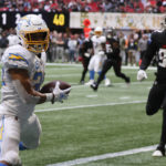 
              CORRECTS DATE TO SUNDAY, NOV. 6 INSTEAD OF TUESDAY, DEC. 6 - Los Angeles Chargers running back Austin Ekeler (30) catches a 1-yard touchdown pass ahead of Atlanta Falcons linebacker Adetokunbo Ogundeji (92) during the first half of an NFL football game, Sunday, Nov. 6, 2022, in Atlanta. (AP Photo/Butch Dill)
            