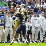 Notre Dame wide receiver Braden Lenzy catches the ball against Navy cornerback Mbiti Williams Jr. (7) for a touchdown during the first half of an NCAA college football game, Saturday, Nov. 12, 2022, in Baltimore. (AP Photo/Terrance Williams)