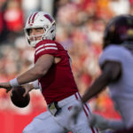 
              Wisconsin quarterback Graham Mertz (5) passes as Minnesota defensive back Beanie Bishop (7) pressures during the first half of an NCAA college football game Saturday, Nov. 26, 2022, in Madison, Wis. (AP Photo/Andy Manis)
            