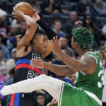 Detroit Pistons guard Jaden Ivey (23) looks to pass as Boston Celtics guard Marcus Smart (36) defends during the second half of an NBA basketball game, Saturday, Nov. 12, 2022, in Detroit. (AP Photo/Carlos Osorio)