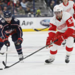 Columbus Blue Jackets' Liam Foudy, left, and Detroit Red Wings' David Perron chase a loose puck during the third period of an NHL hockey game on Saturday, Nov. 19, 2022, in Columbus, Ohio. (AP Photo/Jay LaPrete)