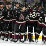 Arizona Coyotes' Troy Stecher (51) celebrates with Matias Maccelli (63) and other teammates after the team's 3-1 win in an NHL hockey game against the Florida Panthers in Tempe, Ariz., Tuesday, Nov. 1, 2022. (AP Photo/Ross D. Franklin)