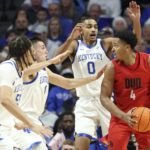 
              Duquesne's Tre Williams (4) is pressured by, from left to right, Kentucky's Lance Ware, CJ Fredrick, and Jacob Toppin during the second half of an NCAA college basketball game in Lexington, Ky., Friday, Nov. 11, 2022. (AP Photo/James Crisp)
            