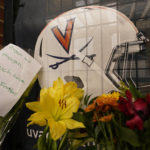 
              Memorial flowers and notes line walkway at Scott Stadium after three football players were killed in a shooting on the grounds of the University of Virginia Tuesday Nov. 15, 2022, in Charlottesville. Va. (AP Photo/Steve Helber)
            