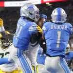 Detroit Lions safety Kerby Joseph (31) intercepts a pass intended for Green Bay Packers wide receiver Christian Watson during the first half of an NFL football game, Sunday, Nov. 6, 2022, in Detroit. (AP Photo/Paul Sancya)