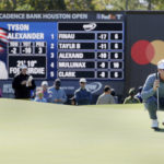 
              Tyson Alexander checks the lie on the seventh green in front of a leader board with his statistics during the final round of the Houston Open golf tournament, Sunday, Nov. 13, 2022, in Houston. (AP Photo/Michael Wyke)
            