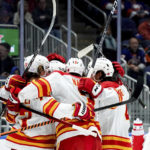 
              Calgary Flames right wing Tyler Toffoli (73), defenseman Connor Mackey (3) and others celebrate center Mikael Backlund's (11) goal during the first period of an NHL hockey game against the New York Islanders, Monday, Nov. 7, 2022, in Elmont, N.Y. (AP Photo/Julia Nikhinson)
            