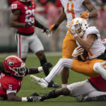 Tennessee wide receiver Jalin Hyatt (11) is dragged down by Georgia defensive back Malaki Starks (24) after a catch during the first half of an NCAA college football game Saturday, Nov. 5, 2022 in Athens, Ga. (AP Photo/John Bazemore)