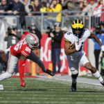 
              Michigan receiver Cornelius Johnson, right, turns up field to score a touchdown past Ohio State defensive back Cameron Brown during the first half of an NCAA college football game on Saturday, Nov. 26, 2022, in Columbus, Ohio. (AP Photo/Jay LaPrete)
            