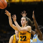 Iowa guard Caitlin Clark (22) passes ahead of Southern guard Chloe Fleming, right, during the first half of an NCAA college basketball game, Monday, Nov. 7, 2022, in Iowa City, Iowa. (AP Photo/Charlie Neibergall)