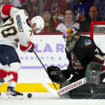 Arizona Coyotes goaltender Karel Vejmelka, right, makes a save on a shot by Florida Panthers right wing Patric Hornqvist (70) during the third period of an NHL hockey game in Tempe, Ariz., Tuesday, Nov. 1, 2022. The Coyotes won 3-1. (AP Photo/Ross D. Franklin)