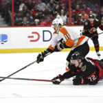 
              Ottawa Senators defenseman Thomas Chabot (72) falls on the ice as he knocks the puck away from Philadelphia Flyers right wing Travis Konecny (11) to prevent him from breaking away during the first period of an NHL hockey game, Saturday, Nov. 5, 2022 in Ottawa, Ontario. (Justin Tang/The Canadian Press via AP)
            