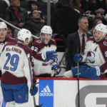 Colorado Avalanche center Nathan MacKinnon (29) is congratulated by teammates after scoring a goal against the Washington Capitals during the second period of an NHL hockey game Saturday, Nov. 19, 2022, in Washington. (AP Photo/Jess Rapfogel)