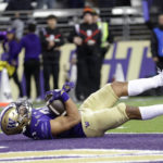 Washington running back Wayne Taulapapa (21) tumbles into the end zone for a touchdown against Oregon State during the second half of an NCAA collage football game Friday, Nov. 4, 2022, in Seattle. (AP Photo/John Froschauer)