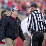 
              Wisconsin interim head coach Jim Leonhard talks with an official during the first half of an NCAA college football game against Minnesota, Saturday, Nov. 26, 2022, in Madison, Wis. (AP Photo/Andy Manis)
            