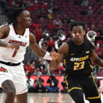 Appalachian State guard Terence Harcum (23) drives past Louisville guard Mike James (1) during the first half of an NCAA college basketball game in Louisville, Ky., Tuesday, Nov. 15, 2022. (AP Photo/Timothy D. Easley)