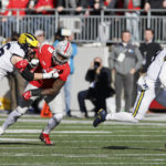 
              Michigan quarterback J.J. McCarthy, right, scrambles away from Ohio State defensive lineman Zach Harrison during the first half of an NCAA college football game on Saturday, Nov. 26, 2022, in Columbus, Ohio. (AP Photo/Jay LaPrete)
            