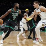 Boston Celtics' Jaylen Brown (7) looks to move against Denver Nuggets' Nikola Jokic (15) during the first half of an NBA basketball game, Friday, Nov. 11, 2022, in Boston. (AP Photo/Michael Dwyer)