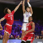 
              This photo provided by Bahamas Visual Services shows Kansas forward Jalen Wilson (10) taking a shot past N.C. State defenders Jack Clark (5) and Casey Morsell (14) during an NCAA college basketball game at the Battle 4 Atlantis at Paradise Island, Bahamas, Wednesday, Nov. 23, 2022.(Tim Aylen/Bahamas Visual Services via AP)
            