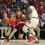 
              Nicholls State guard Pierce Spencer, left, drives on Arizona guard Kylan Boswell during the first half of an NCAA college basketball game, Monday, Nov. 7, 2022, in Tucson, Ariz. (AP Photo/Rick Scuteri)
            