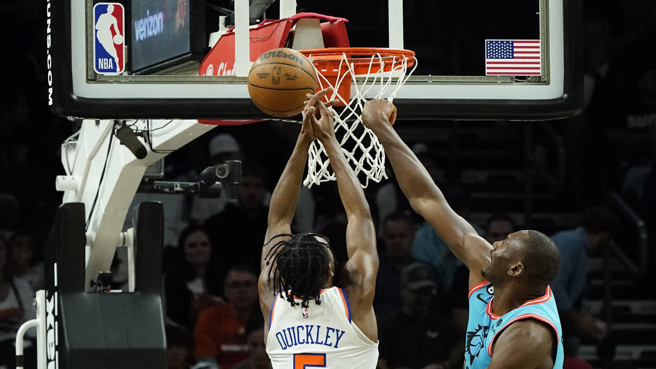 Phoenix Suns center Bismack Biyombo, right, blocks a shot by New York Knicks guard Immanuel Quickle...