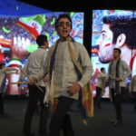 Youngsters perform on stage before the streaming of the soccer match between Iran and the United States in Qatar's World Cup, on the big screen at a cultural center in Tehran, Iran, Tuesday, Nov. 29, 2022. The U.S. team's victory over Iran at the World Cup on Tuesday was closely watched across the Middle East, where the two nations have been engaged in a cold war for over four decades and where many blame one or both for the region's woes. (AP Photo/Vahid Salemi)