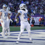 Detroit Lions running back Jamaal Williams (30) reacts after scoring a touchdown during the second half of an NFL football game against the New York Giants, Sunday, Nov. 20, 2022, in East Rutherford, N.J. (AP Photo/Seth Wenig)