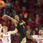 
              Arkansas-Pine Bluff's Kylen Milton (1) passes the ball against Nebraska's Sam Griesel (5) and Jamarques Lawrence (10) during the first half of an NCAA college basketball game on Sunday, Nov. 20, 2022, in Lincoln, Neb. (AP Photo/Rebecca S. Gratz)
            