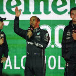From left to right, Sergio Perez, Lewis Hamilton and George Russell stand on stage at a launch party for the Formula One Las Vegas Grand Prix, Saturday, Nov. 5, 2022, in Las Vegas. (AP Photo/John Locher)
