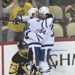 
              Toronto Maple Leafs right wing Mitchell Marner celebrates with center Auston Matthews (34) near Pittsburgh Penguins defenseman Pierre-Olivier Joseph (73) after scoring during the first period of an NHL hockey game, Saturday, Nov. 26, 2022, in Pittsburgh. (AP Photo/Philip G. Pavely)
            